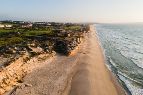 View of the Atlantic ocean and Praia d`El Rey beach at sunset, near Obidos, Portugal