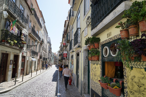 Traditional narrow cobblestone street in the Barrio alto district in Lisbon, Portugal
