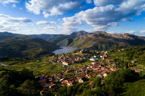 Aerial panoramic view of the historic village of Lindoso, with the surroundings mountains and lake, at the Peneda Geres National Park near Braga and Porto, Portugal Portugal