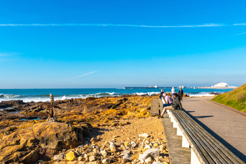 Homem do Leme Beach Picturesque View with Relaxing and Sitting People on a Sunny Blue Sky Day, Porto, Portugal