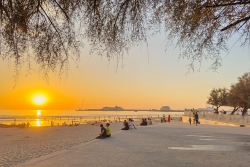Matosinhos beach near Porto with surfers and people watching the sunset, Portugal