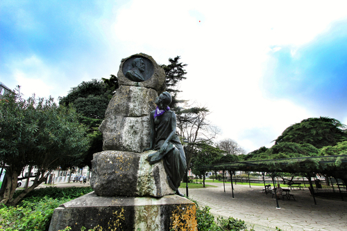 Franga Borges statue with purple scarf tied around the neck for International woman day at Principe Real Garden in Lisbon, Portugal