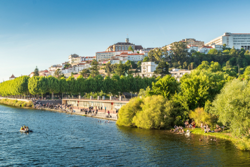 Traditional students' bath in the waters of the Mondego river after the Queima das Fitas parade of the University of Coimbra in Portugal