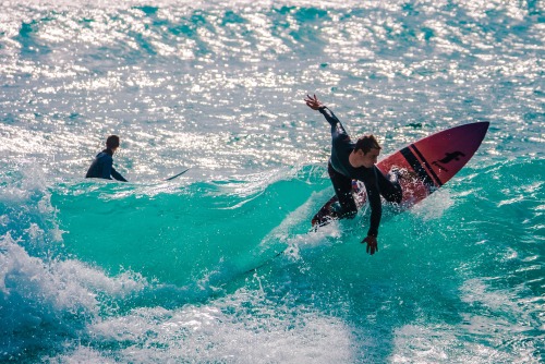 Surfers in Praia do Beliche beach in Sagres, Algarve, Portugal