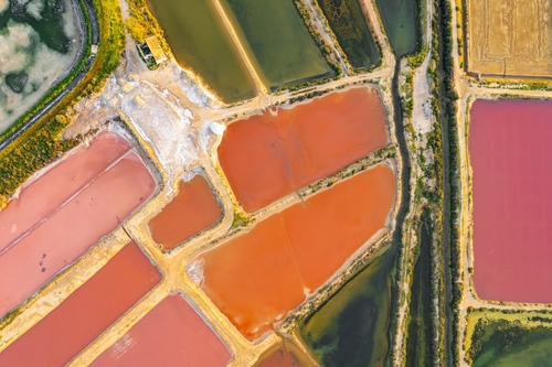 The colorful salt ponds and Saline marshes on the Ria Formosa lagoon in Tavira, Algarve, Portugal. Read about the marshes in thetjoy.com