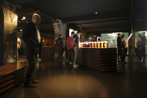 Visitors explore exhibits in a Port wine museum in Porto, Portugal with vintage wine-related decor